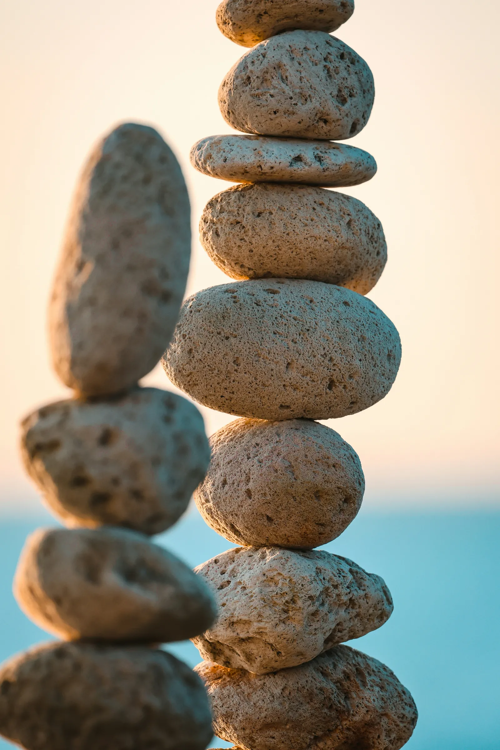 Stacked stones against a soft sky