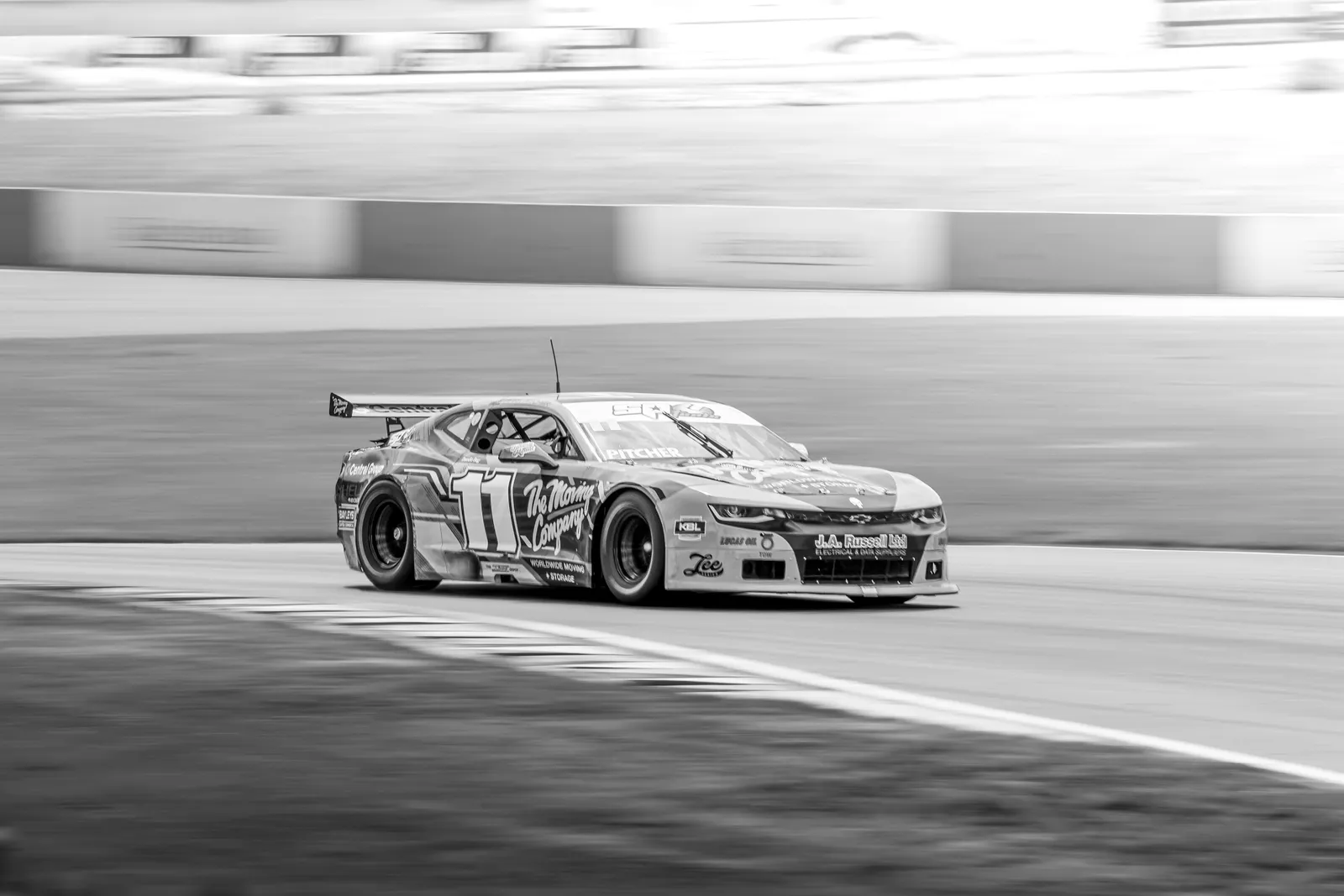 Black and white race car blurred track